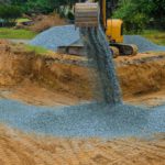 backfill loader dumping in a dirt pit